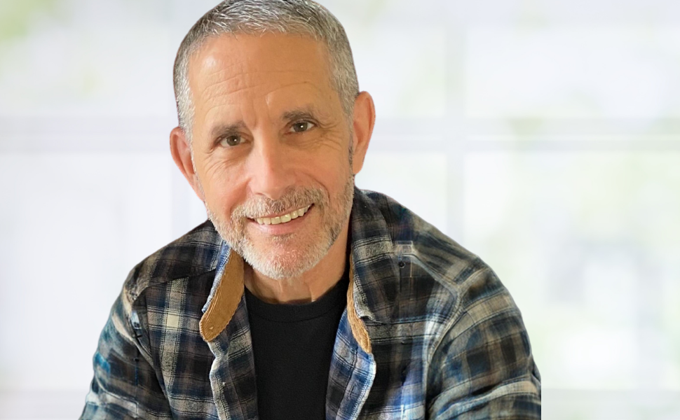 Medium casual shot of author Gregory P. Steffine wearing a plaid shirt with a blurred white background